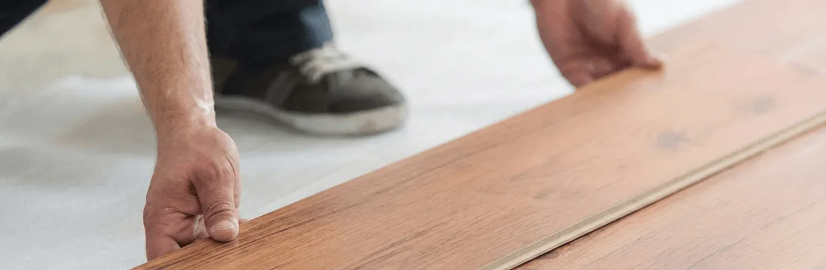 A professional installing laminate flooring in Los Angeles, CA